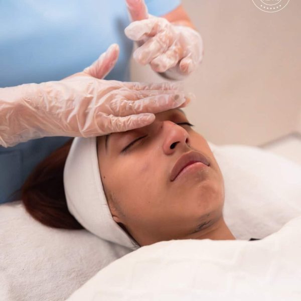 Client receiving a gentle, bespoke facial treatment in the clinic